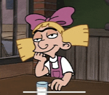 a cartoon character sitting at a table with a glass of milk in front of her