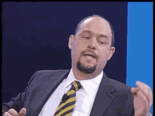 a man in a suit and tie is talking