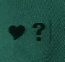 a question mark is next to a heart on a green background