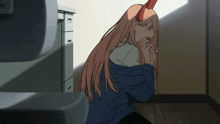 a girl with long hair is sitting on the floor