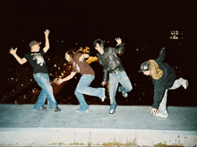 a group of people are posing for a picture and one of them is wearing a shirt that says ' apocalypse '