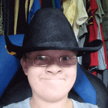 a person wearing a cowboy hat and glasses making a face