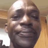 a close up of a man 's face with a tear running down his face .