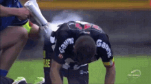 a soccer player wearing a jersey that says gabriel is being sprayed with water