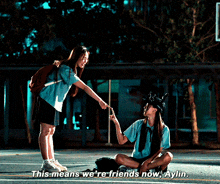 two girls on a basketball court with the words " this means we 're friends now aylin " above them