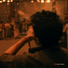 a man sitting in a dark room with a sony music logo