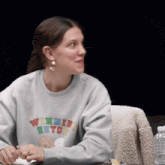 a woman wearing a sweater that says winnie the pooh