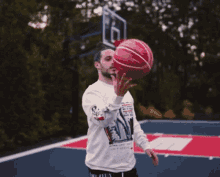 a man standing on a basketball court with his arms outstretched wearing a shirt that says " do it for you only people "