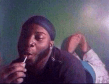 a man with a beard is smoking a cigarette