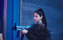 a woman is holding a toy gun in front of a neon sign that says records