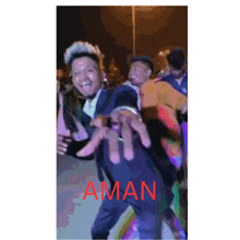 a man in a suit is dancing with the word aman on the bottom right