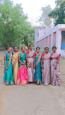 a group of women standing in front of a building