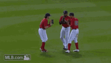 a group of baseball players are standing on a field and one of them has the number 50 on his jersey .