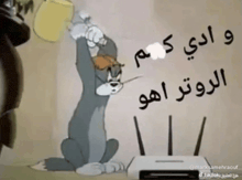 a cartoon of tom and jerry sitting next to a router with arabic writing on it