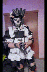 a man in a maid costume is holding a gun ..