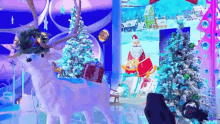 a christmas scene with a reindeer and a christmas tree .