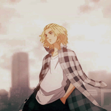 a man in a plaid shirt with his hands in his pockets