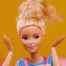 a close up of a barbie doll 's face with blue eyes