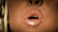 a close up of a woman 's mouth with a piercing