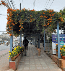 a man walking under a covered walkway with a sign that says mba