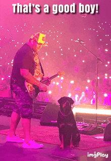 a picture of a man playing a guitar and a dog sitting next to him with the caption that 's a good boy !