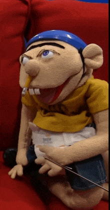 a puppet with a pencil sticking out of his mouth