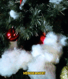 a close up of a christmas tree with the words " vengeance " in yellow letters