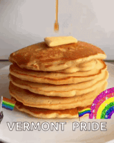 a stack of pancakes with syrup being poured on top and the words vermont pride below it