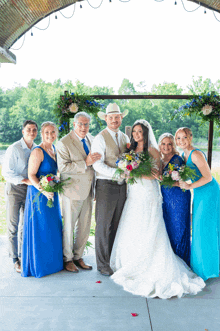 a bride and groom pose for a picture with their wedding party