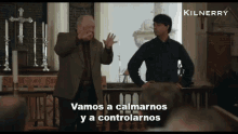 two men standing in a church with the words vamos a calmarnos y a controlarnos on the screen