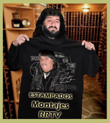 a man with a beard is holding up a black shirt that says " estampados montajes rrtv "