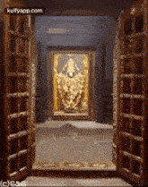 a door is open to a room with a painting of a deity in the corner .