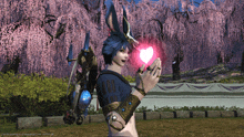 a video game character holding a pink heart in front of cherry blossom trees