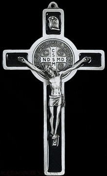 a black and white photo of a cross with jesus on it on a black background .