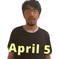 a man wearing glasses and a black shirt with april 5 on it
