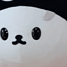 a close up of a stuffed animal with a star in its eye