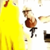 a man is cooking in a kitchen with a yellow chicken and a blue letter p .