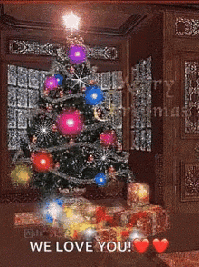 a christmas tree with gifts underneath it and the words we love you on the bottom