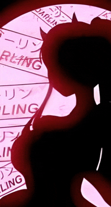 a silhouette of a girl with horns and the word bling on a pink background .