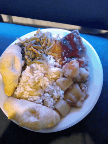 a paper plate filled with a variety of food including shrimp rice and potatoes