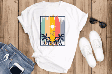 a t-shirt with a picture of palm trees and the sun on it