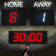 a scoreboard shows that the home team is leading the away team by 1