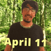 a man in a black shirt with the date april 11 on it