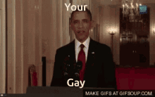 a man in a suit and tie stands at a podium with the words " your gay " on the bottom