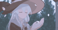 a girl with white hair wearing a witch hat is holding something in her hands