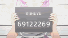 a girl holding up a sign that says ruhuyu