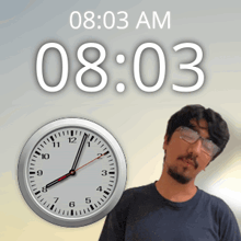 a man stands in front of a clock that says 08:03