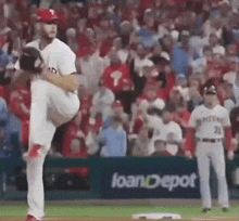 a baseball pitcher is about to throw a ball in front of a loandepot sign