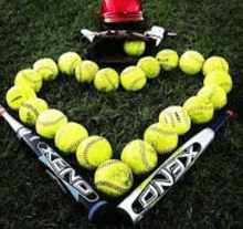 a heart made out of softball balls , bats , and a helmet .