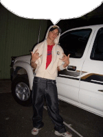 a man in a hoodie is standing next to a white truck .